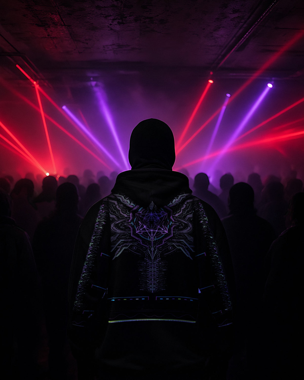 Neon Sigil hoodie back under laser show, crowd from behind